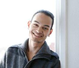 Gentleman smiling and leaning on the wall